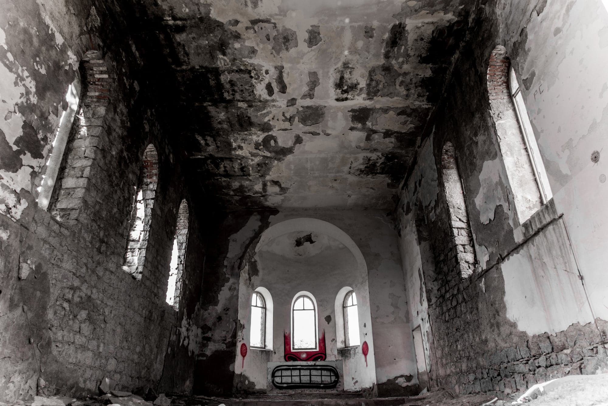 A ruined church interior, in black and white