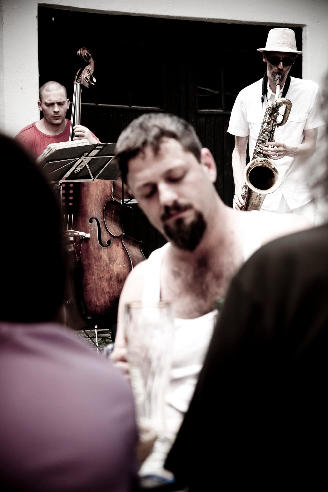 A trio mid-set — bass, saxophone, voice