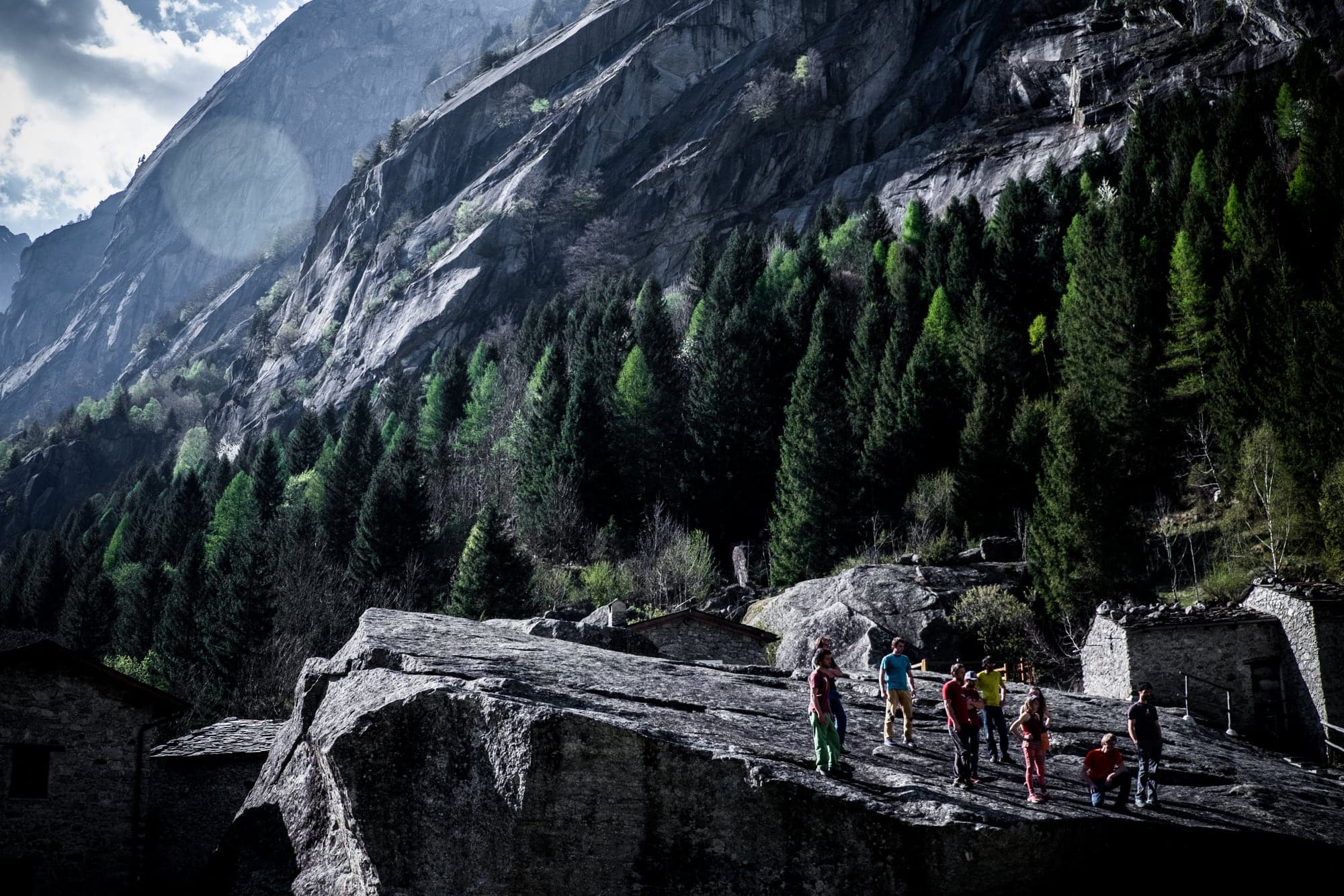 People crossing an old stone bridge, seen from above