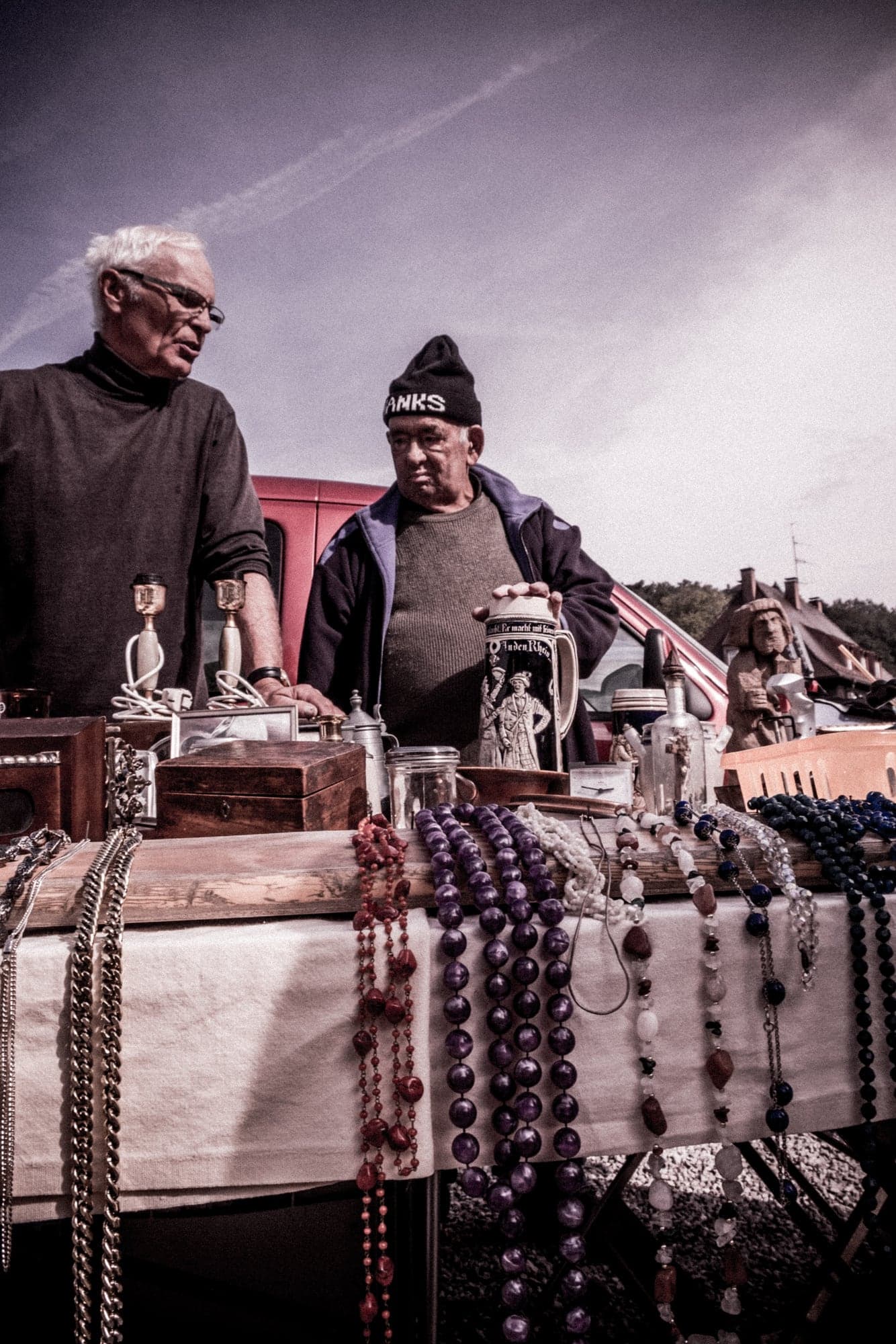 Two men behind a flea-market stall
